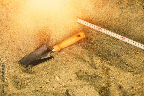 Shovel in the sand.Skeleton and archaeological tools.Digging for fossils. photo