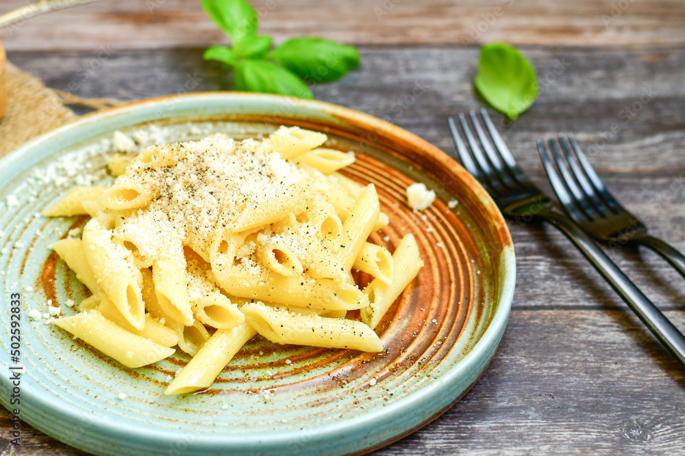 Home made italian Penne rigate Pasta with parmesan cheese,garlic and black pepper .Pasta cacio e pepe. Mediterranean food concept Home made italian Penne rigate Pasta with parmesan cheese,garlic and black pepper .Pasta cacio e pepe. Mediterranean food concept