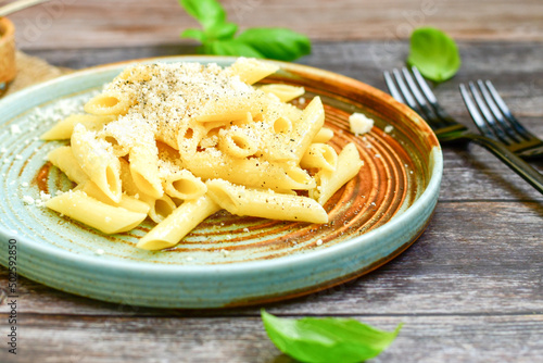  Home made italian penne rigate pasta with parmesan cheese,garlic and black pepper .Pasta cacio e pepe. Mediterranean food concept