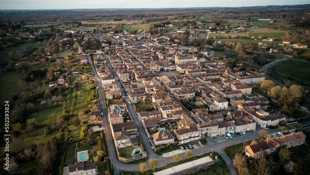 Beautiful wide drone shot of the little village of Monpazier in Périgord at sunset, Dordogne