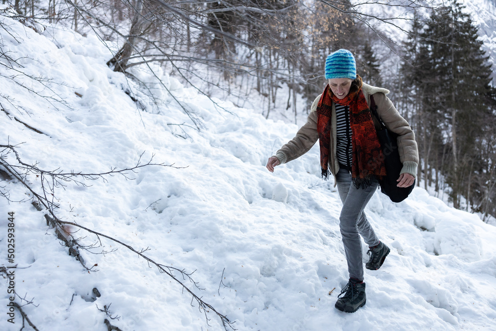 Hiker carefully walking uphill on Icy Path