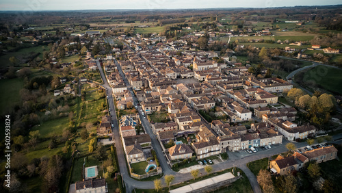 Beautiful wide drone shot of the little village of Monpazier in Périgord at sunset, Dordogne