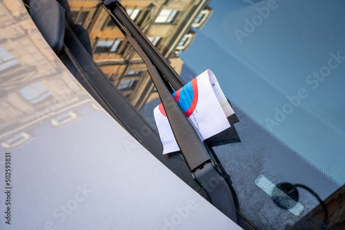 Strafzettel an falsch parkendem Auto unter Scheibenwischer photo