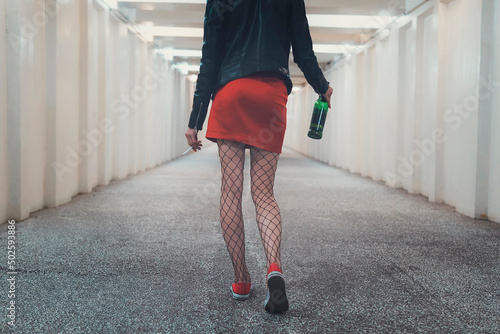 Fotografija Drunk young woman walking down the hall smoke cigarettes