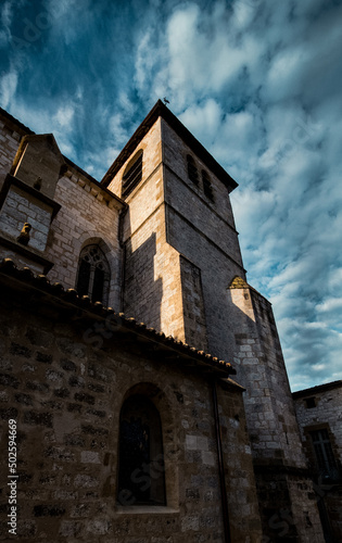 Sunset on a old catholic church, Saint Dominique de Monpazier, in Dordogne, Nouvelle -Aquitaine - The sky is blue dark, dramatic mood