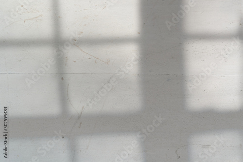 Top view flat lay background with organic window lights and shadows, bokeh, and texture on a scuffed and scratched wooden surface background. Minimal summer lights and shadow concept.