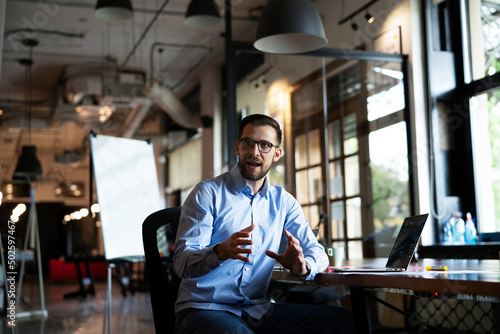 Young businessman using laptop in his office. Handsome man working in the office