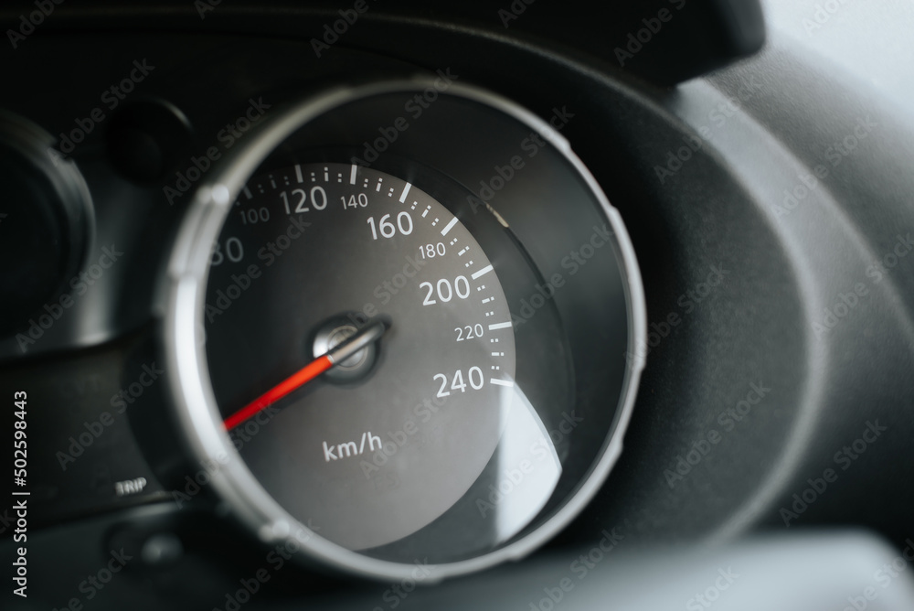 Close-up of car speedometer with red arrow and dial. Side view dashboard Close-up of car speedometer with red arrow and dial. Side view dashboard