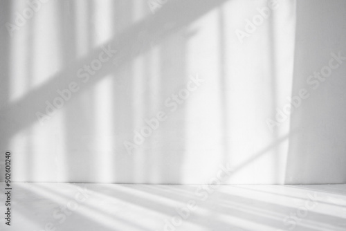Abstract white background. Shadows on a white table and a white wall.