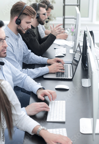Obraz na płótnie Call centre employees working on computers with their headset