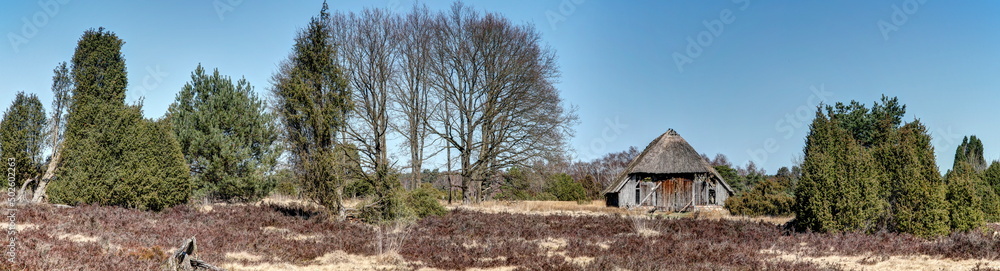 The Lüneburg Heath impresses in every season with impressive views over the heath landscape with the lonely and dilapidated old sheepfold. The Lüneburg Heath impresses in every season with impressive views over the heath landscape with the lonely and dilapidated old sheepfold.