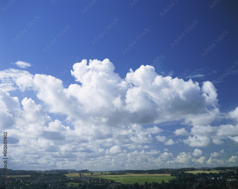 Blue sky and fluffy clouds over a landscape Blue sky and fluffy clouds over a landscape