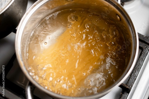 Spaghetti is boiled in water. Cooking Italian pasta at home.