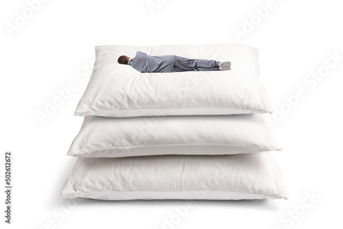 Rear view shot of a man sleeping on a pile of big pillows