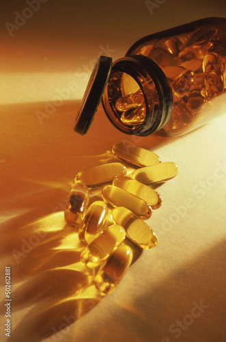 Close-up of an open bottle of vitamin tablets photo