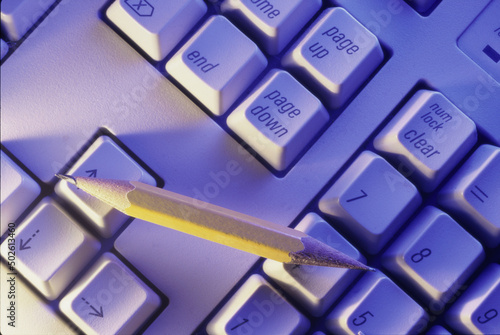 High angle view of a pencil on a computer keyboard photo