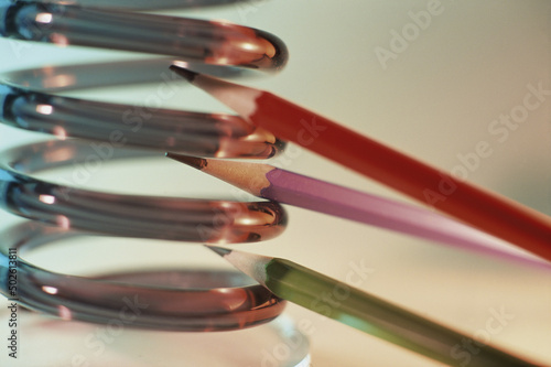 Pencils between spring coils photo