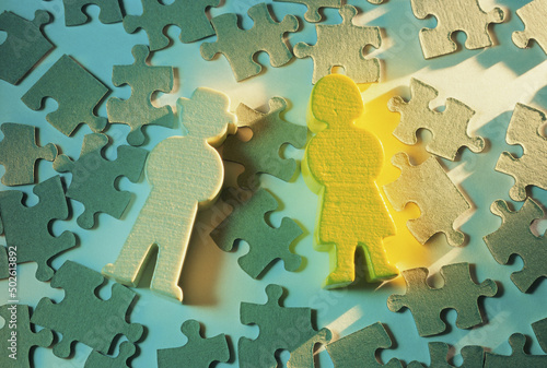 Close-up of human cutouts on jigsaw puzzle pieces photo