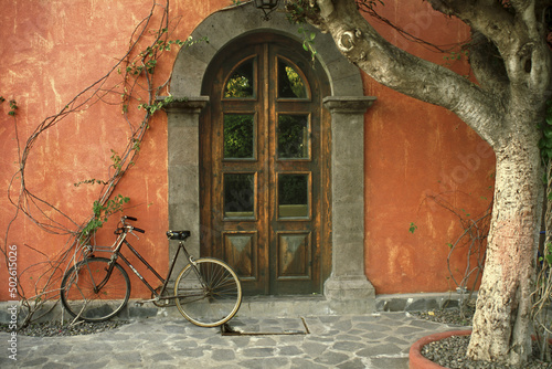 Bicycle parked in front of a door, Posada de las Flores Hotel, Loreto, Mexico photo