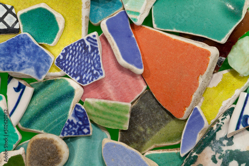 Multi colored broken crockery, close-up photo
