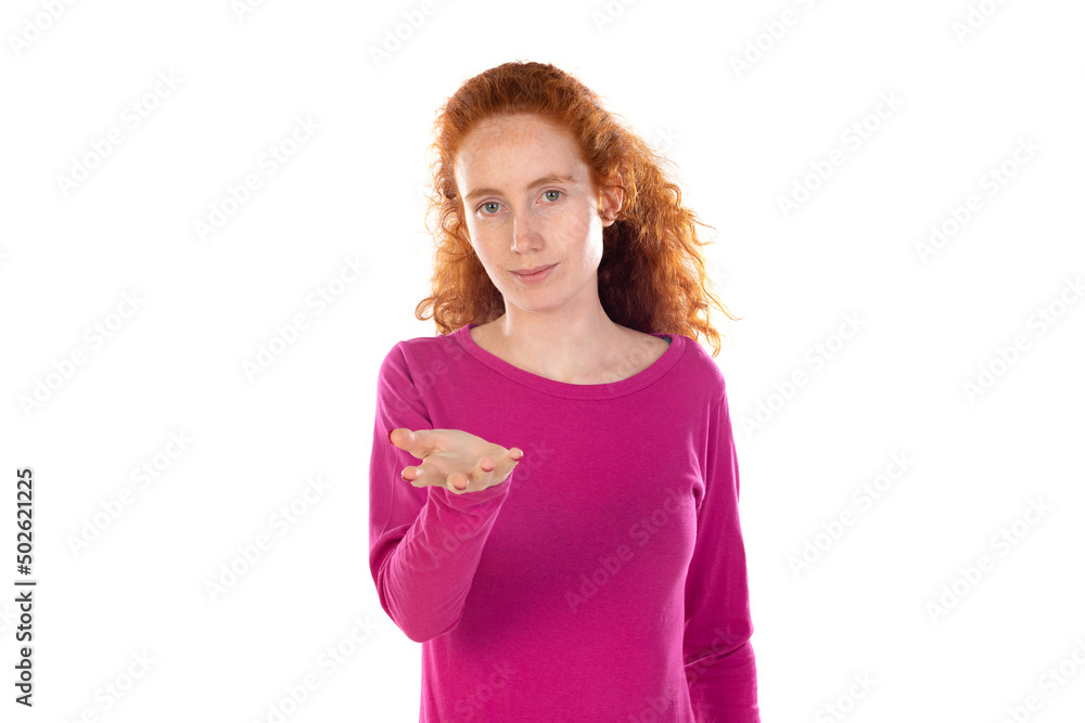 Young redhead girl smiling friendly offering something with open hand