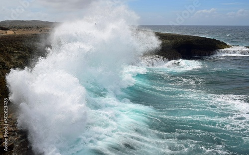 Seascape with view of the north west shore of Curacao at Boka Tabla in the Shete Boka National park  huge wave crashing into the cliff with a big splash