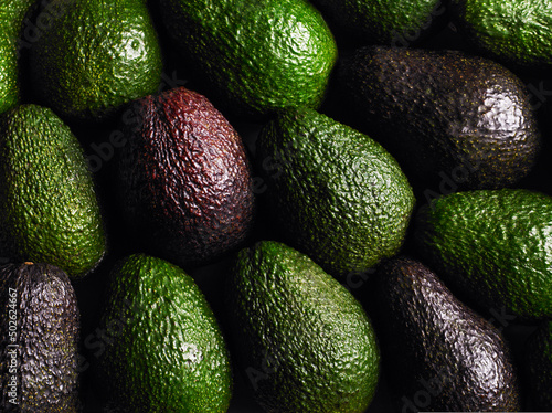 Close up of green and purple avocados photo