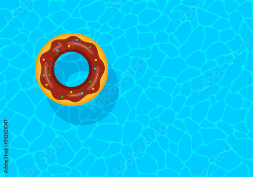Swimming pool with floating inflatable rubber chocolate donut. Top view