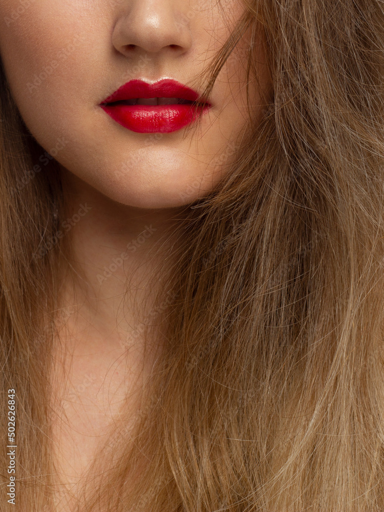 Fototapeta premium Sexual full lips. Natural gloss of lips and woman's skin. The mouth is closed. Increase in lips, cosmetology. red lips. Great summer mood with open eyes. fashion jewelry. pink lip gloss