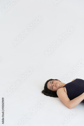 Sporty young woman doing relaxing yoga practice isolated on white background. Concept of healthy life and natural balance between body and mental development. Full length