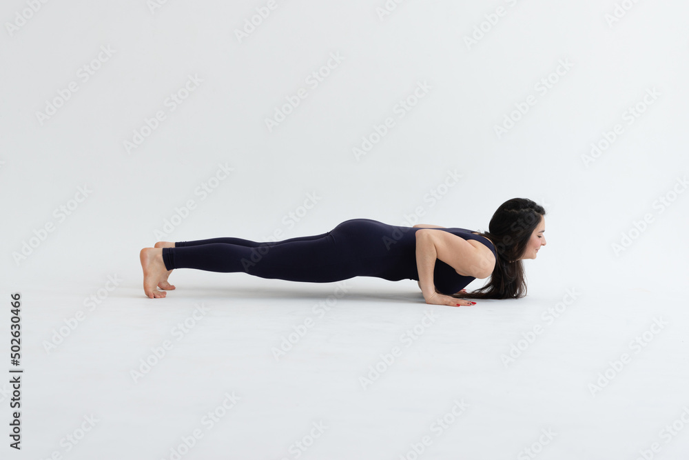 Healthy woman practicing relaxation yoga on a white background. making yoga exercises at studio. Healthy woman practicing relaxation yoga on a white background. making yoga exercises at studio.
