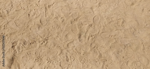 brown dry Sand texture. Sandy beach for background. Top view. Natural sand stone texture background. sand or soil on the beach as background. Wavy sand background for summer designs. closeup top view.