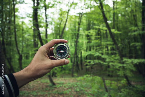 Obraz na płótnie Compass in man hand in forest
