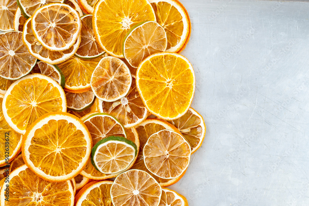 dried citrus fruits on a grey metallic background, space for text. High quality photo dried citrus fruits on a grey metallic background, space for text. High quality photo