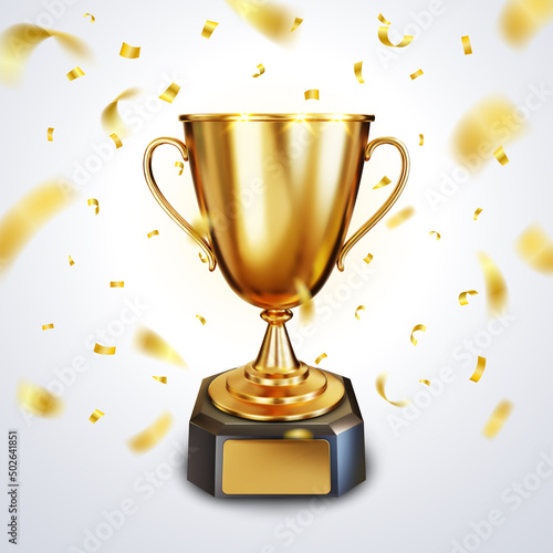 Fotografija Golden trophy cup or champion cup with a blank gold plate for your text and falling shiny golden confetti