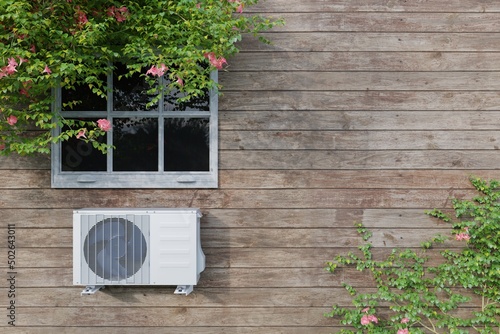 outdoor air conditioner unit on a wooden house with a window and plants. 3d photo