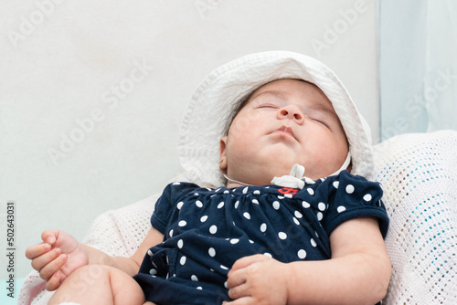 beautiful four month old baby latina sleeping peacefully in her room. lying on a white pillow and dreaming peacefully. concept of restfulness. photo