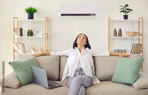 Canvastavla Woman enjoying modern AC system in her home