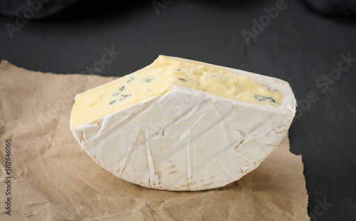 bergader blue cheese on a black wooden board, delicious snack photo