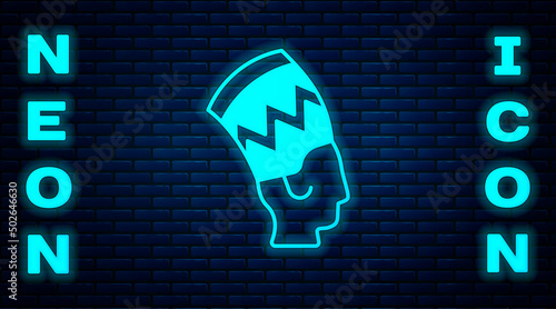 Glowing neon Nefertiti icon isolated on brick wall background. Vector