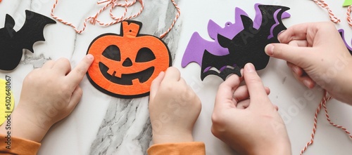 Children siblings sister and brother making decorations for Halloween party celebration. Do it yourself, diy, creativity, holiday concept. Banner.
