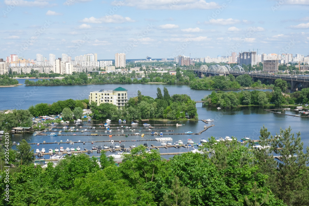 View of the city of Kiev and the Dnieper River. A cityscape on a summer, sunny day. High quality photo