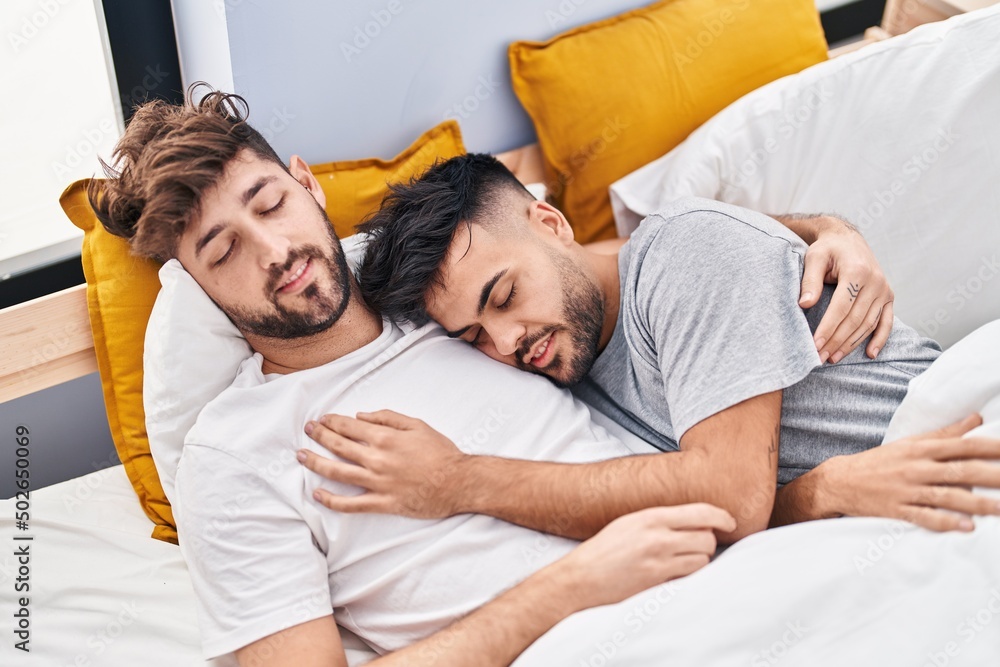 Young couple hugging each other sleeping on bed at bedrooom Young couple hugging each other sleeping on bed at bedrooom