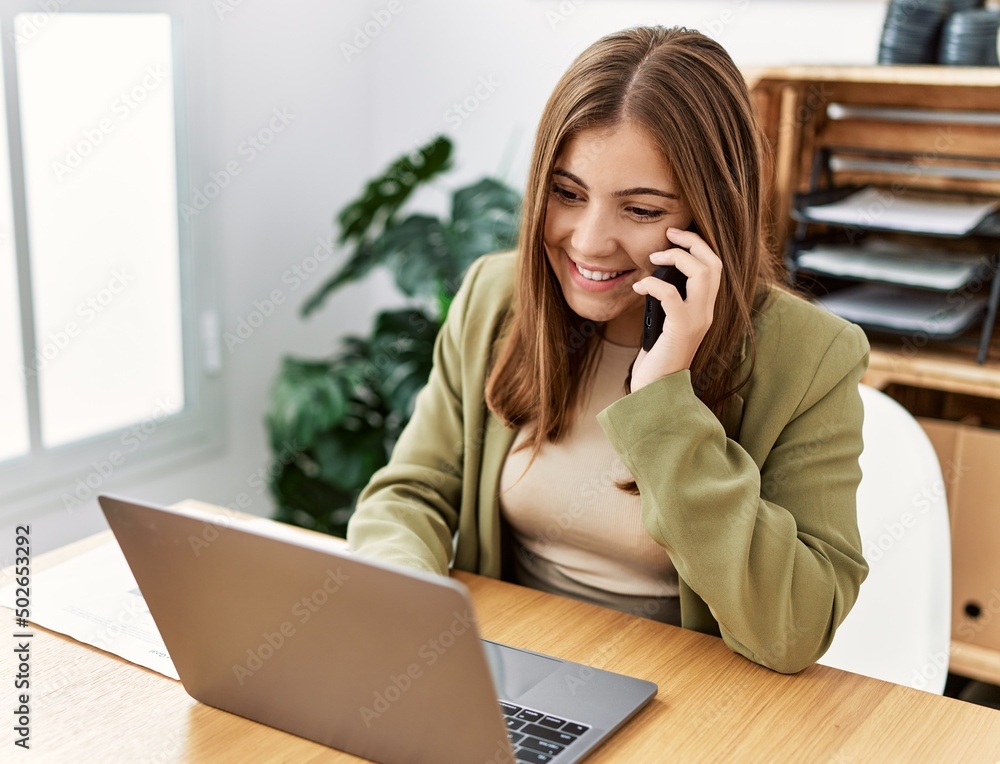 Young hispanic woman talking on the smartphone working at office Young hispanic woman talking on the smartphone working at office