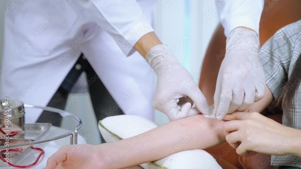 The doctor is using a cotton swab to stop the bleeding for the blood donor on the arm after the blood donation is complete.
The doctor is using a cotton swab to stop the bleeding for the blood donor on the arm after the blood donation is complete.