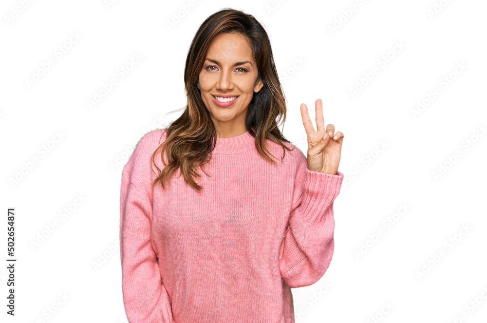 Young hispanic woman wearing casual clothes smiling looking to the camera showing fingers doing victory sign. number two. Young hispanic woman wearing casual clothes smiling looking to the camera showing fingers doing victory sign. number two.