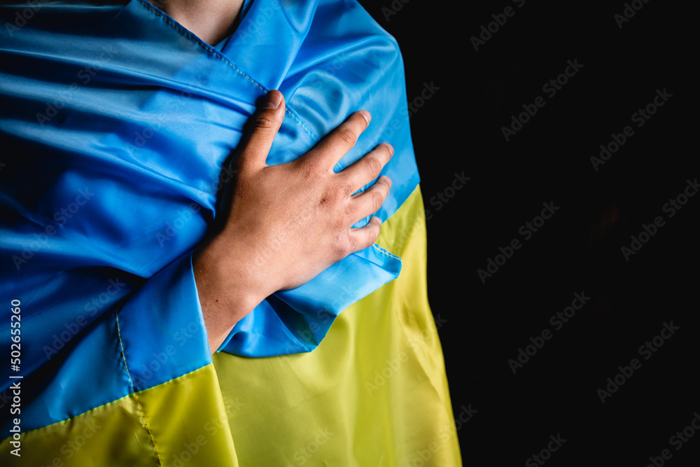 Hand on the background of the Ukrainian flag. Bloody hand.