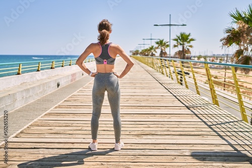 Young caucasian woman wearing sportswear at seaside