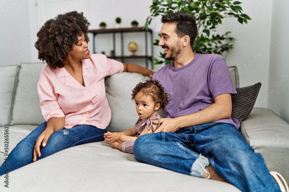 Couple and daughter smiling confident sitting on sofa at home Couple and daughter smiling confident sitting on sofa at home