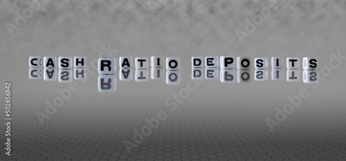 cash ratio deposits word or concept represented by black and white letter cubes on a grey horizon background stretching to infinity